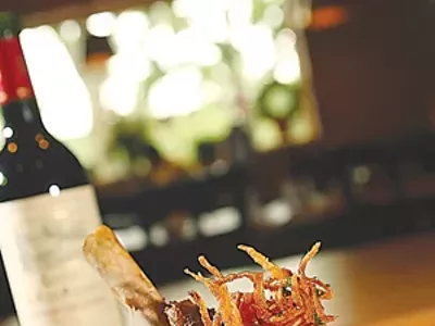 Braised Australian lamb shank with sun-dried tomato and chevre risotto.