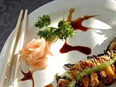 Key West roll with spicy tuna inside, BBQ eel on top and eel sauce, and wasabi tobigo shaped like a dragon from Sala Thai in Detroit.