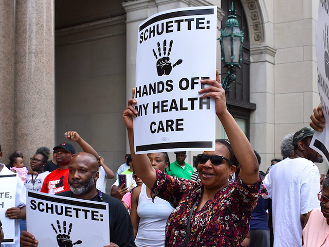 Protesters fight Medicaid work requirements outside the Detroit office gubernatorial candidate and Attorney General Bill Schuette in May.