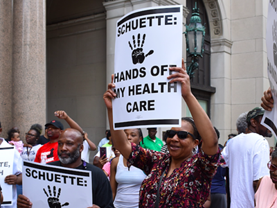 Protesters fight Michigan's Medicaid work requirements outside the Detroit office of gubernatorial candidate and Attorney General Bill Schuette.