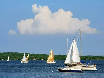 Sailboats on the blue water of Grand Traverse Bay.