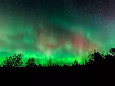 Northern Lights over Benzie County Michigan wooded area.