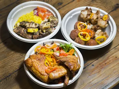 Suya fried chicken (bottoam), lemon jerk chicken (left), corn cakes and plantain wontons (right).