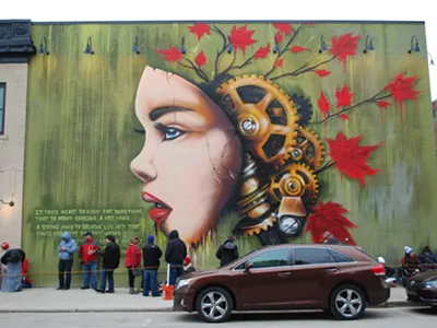 The artist Fel3000ft was commissioned to paint a mural on the side of Detroit's HopCat.