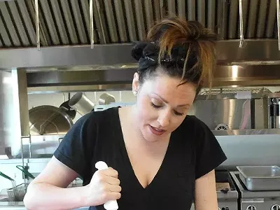 Chef Kate Williams breaking down a lamb at Eastern Market.