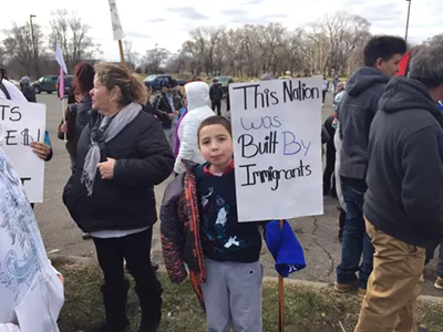 A little boy protests the Trump administration's immigration agenda in southwest Detroit on 'A Day Without Immigrants."