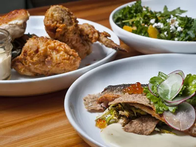 Clockwise, from left: 1/2 Chicken 2 Ways, Loup de Mer, and Kale and Grain salad.