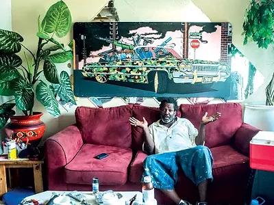 Detroit artist “Bird,” photographed at his home and studio. Vergara's book has Bird asking, "How come people from all over the world are coming to Detroit and making it and people from here can't get shit?"