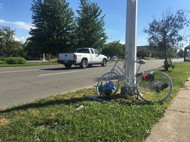 A “ghost bike” shrine memorializes a cyclist killed on Warren Avenue near the Chrysler Service Drive.