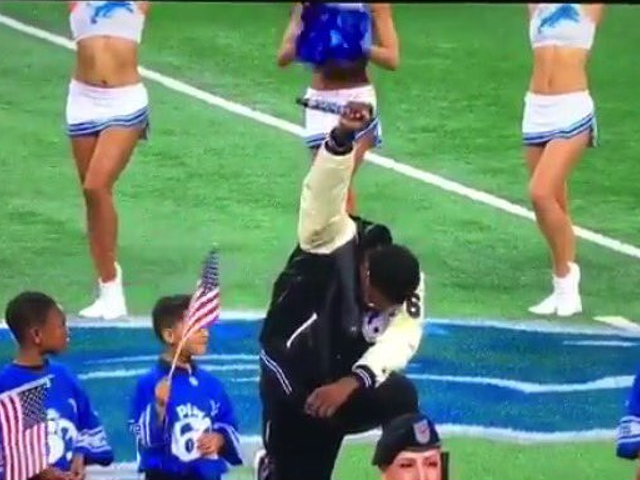 Detroit singer Rico Lavelle takes a knee during national anthem during Lions game