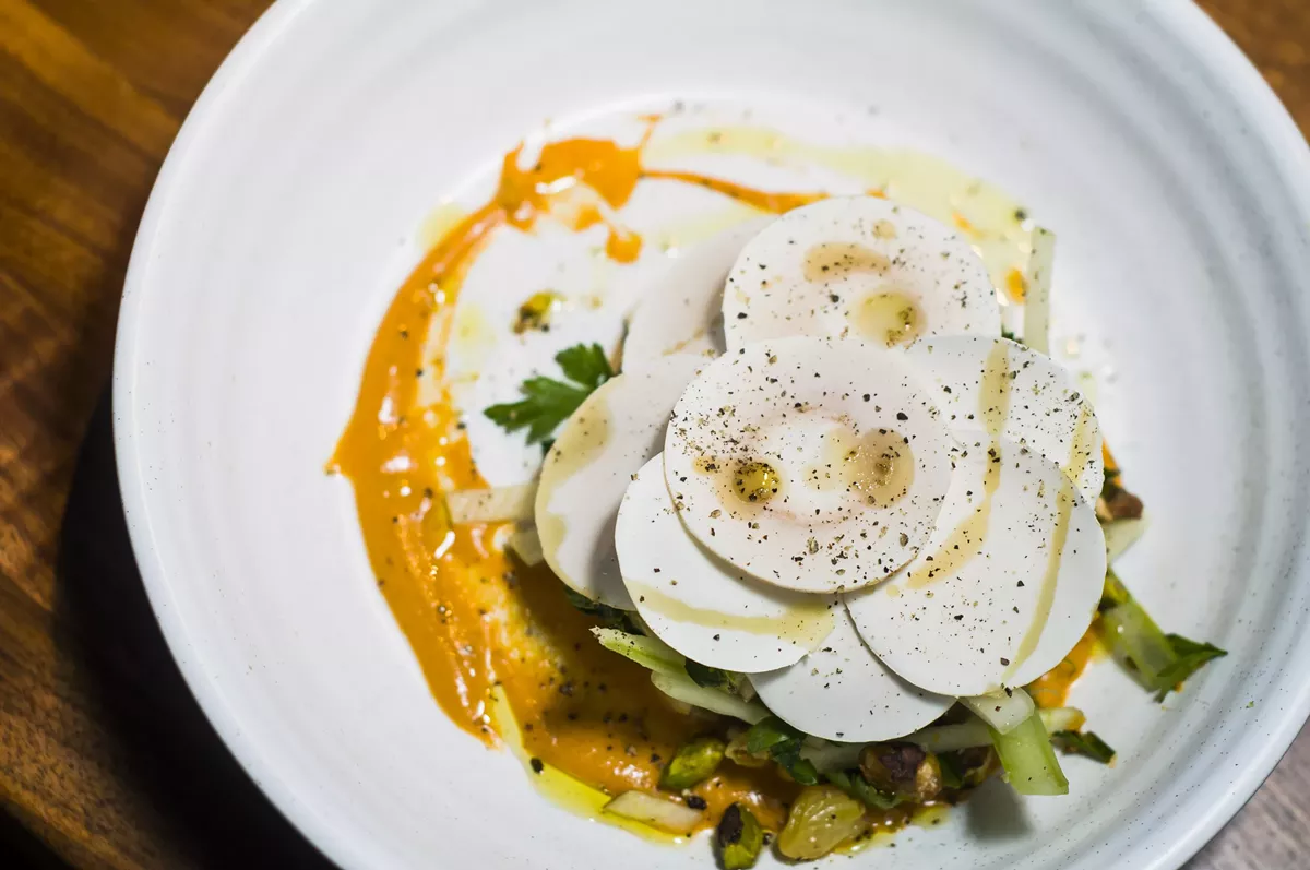 Image: Apple and celery salad with shaved mushroom and persimmon purée.