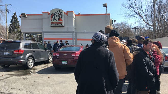 A line snakes around the parking lot of the Little Caesars in Ferndale ahead of Monday's free lunch combo promo.