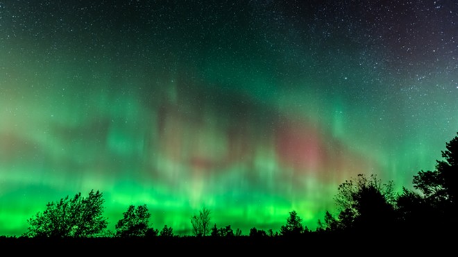 Northern Lights over Benzie County Michigan wooded area.