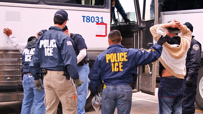 ICE special agents arresting suspects during a raid.