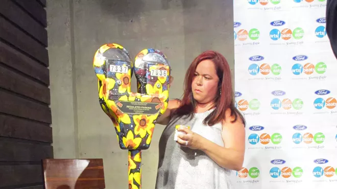 Maria Elliott puts the finishing touches on her illustrated parking meter for the Meters Made Beautiful project.