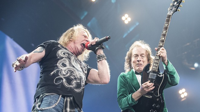 Axl Rose and Angus Young onstage at The Palace of Auburn Hills on Friday.