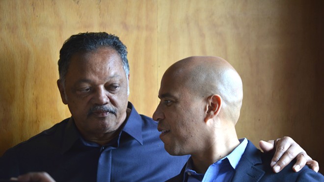 The Rev. Jesse Jackson and U.S. Sen. Cory Booker chat Thursday at Kuzzo's Chicken & Waffles in Detroit.
