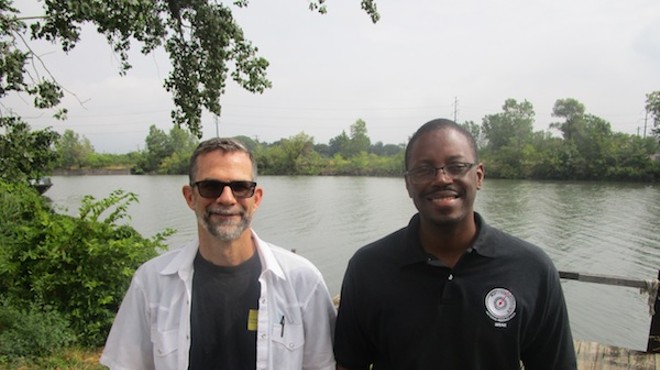 Paul Draus and Brian Yopp stand where they hope to see a park along the Rouge River.