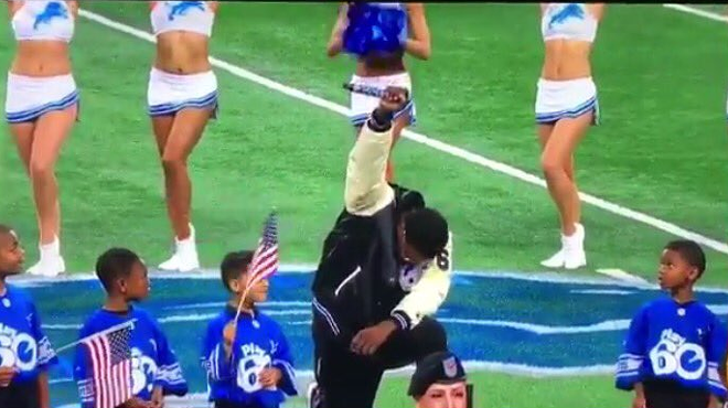 Detroit singer Rico Lavelle takes a knee during national anthem during Lions game