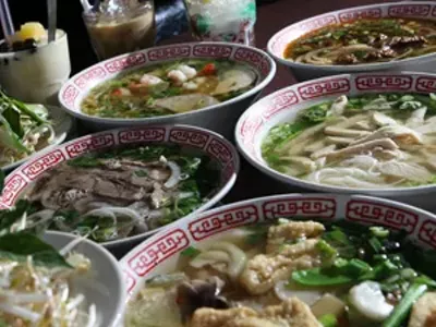 Veggie Tofu Pho, front right, Beef Pho, left, Seafood Pho, back left, Chicken Pho, center right, and Beef Chili Hue Soup, back right