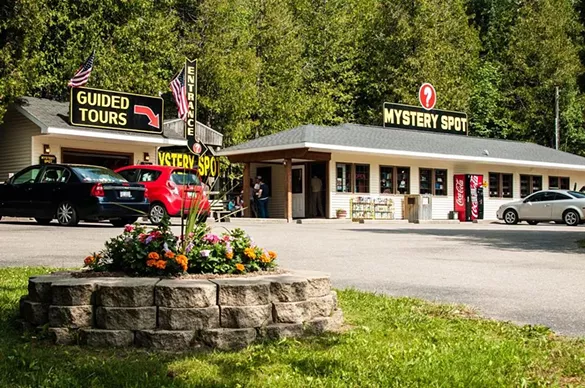 St. Ignace Mystery Spot St. Ignace, MI Shows gravity in a different way. Features optical contradictions and weird physical sensations. Shows buildings turned in weird angles to give an unbalanced effect. Other activities include zip lining and putt putt golf. Photo via atlasobscura.com