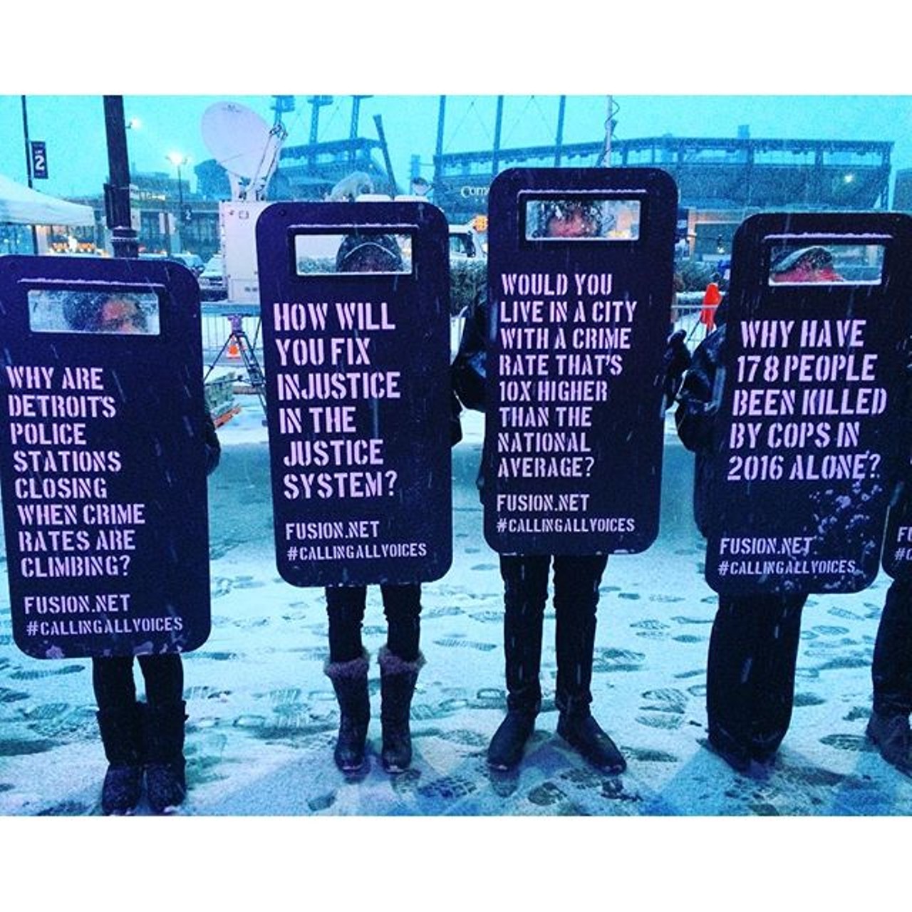 Each riot shield contained a question, challenging the candidates to take a stand on issues of public safety and criminal justice reform&#133; subjects that were notably absent from the discussion going on inside. Photo via Instagram user @ra_meen