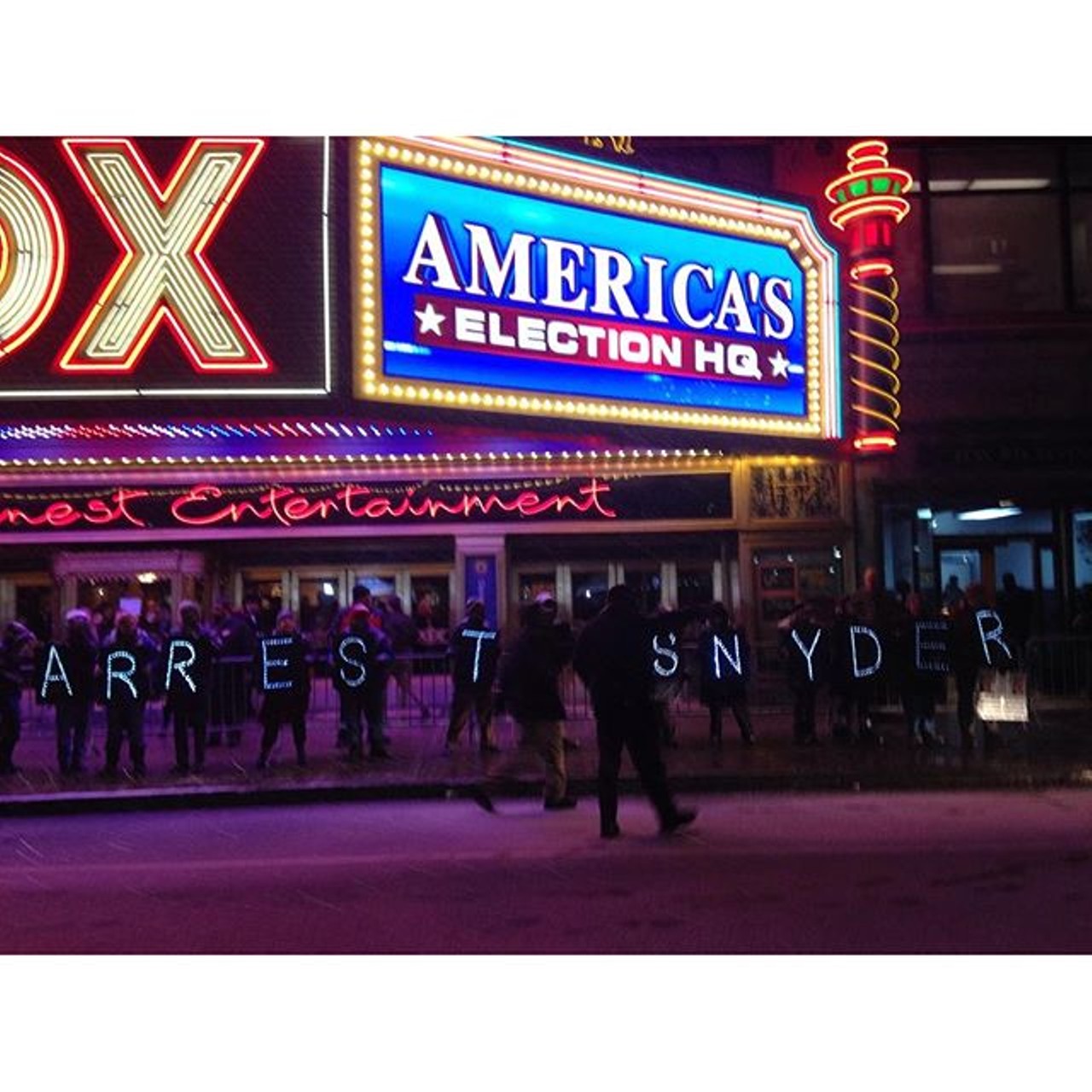 The words &#147;arrest Snyder&#148; shone in the night in front of the debate venue. 
Photo via Instagram user @MsLadyJustice1