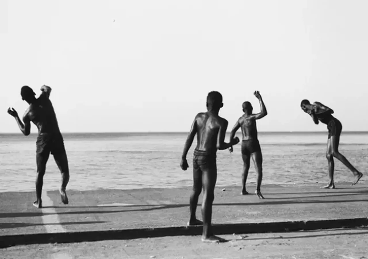 Boys throwing rocks into Lake Michigan, Chicago - "The way these guys are moving, it's like ballet, really. And if you look, each one of the kids is in a different part of the throwing motion."
