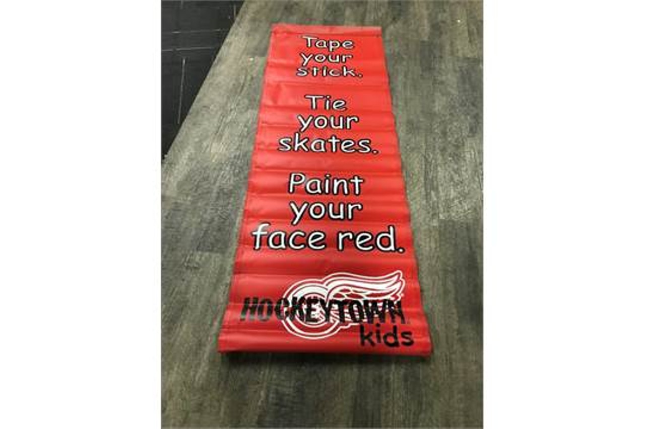 "Tape your stick, tie your skates, paint your face red" banner.