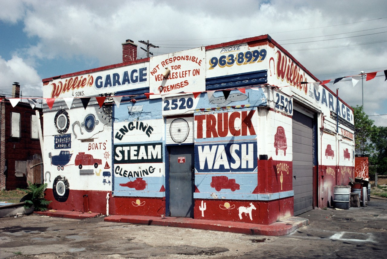A homeless folk artist approached the owner of Willie's Garage about painting the fa&ccedil;ade. The artist painted the story of transportation, a playful arrangement of letters, vehicles, and animals ranging from donkeys to jet planes. In 2015 the former garage is being refurbished. 2520 Michigan Ave., Detroit, 1991.