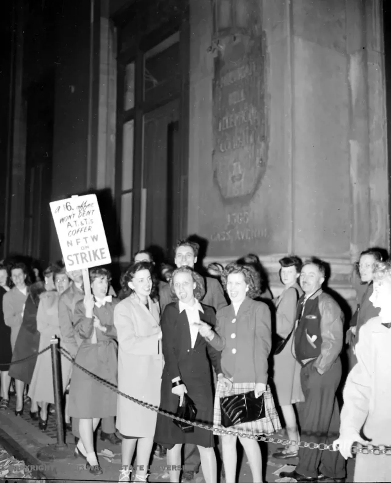 1940s | Group of primarily female striking workers picket in front of AT&T building in Detroit, Michigan.