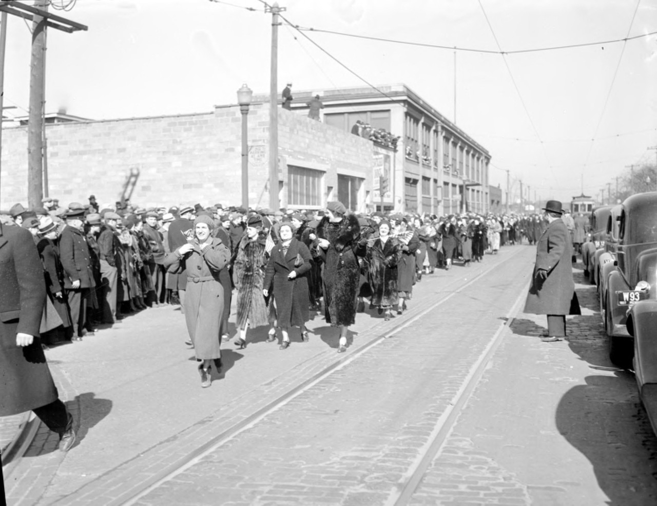 1930s | A large group of women march down Detroit, Michigan street in support of striking U.A,W. workers at Dodge. "The sit-downers were supported by thousands of pickets, a mass demonstration of more than 50,000 in Cadillac Square and a Women's Auxiliary that conducted various activities to boost morale on and off the picket line..." from American Vanguard: The United Auto Workers During the Reuther Years, 1935-1970, by John Barnard.