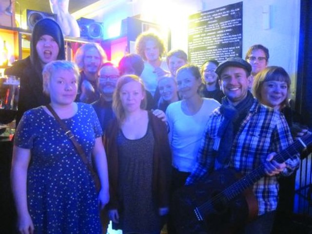 Helsinki musicians gather after their concluding live concert. TACP founder Dave Adams is in the forground holding the guitar.