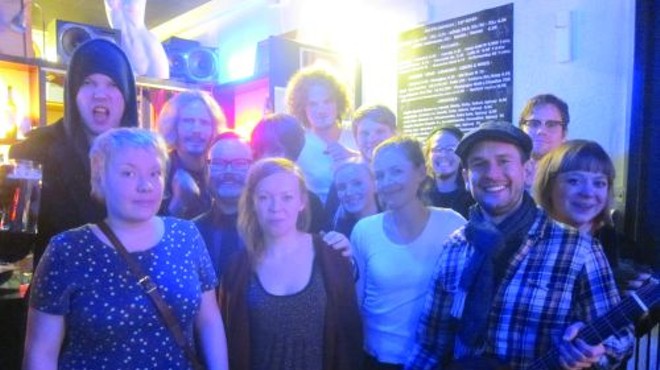 Helsinki musicians gather after their concluding live concert. TACP founder Dave Adams is in the forground holding the guitar.