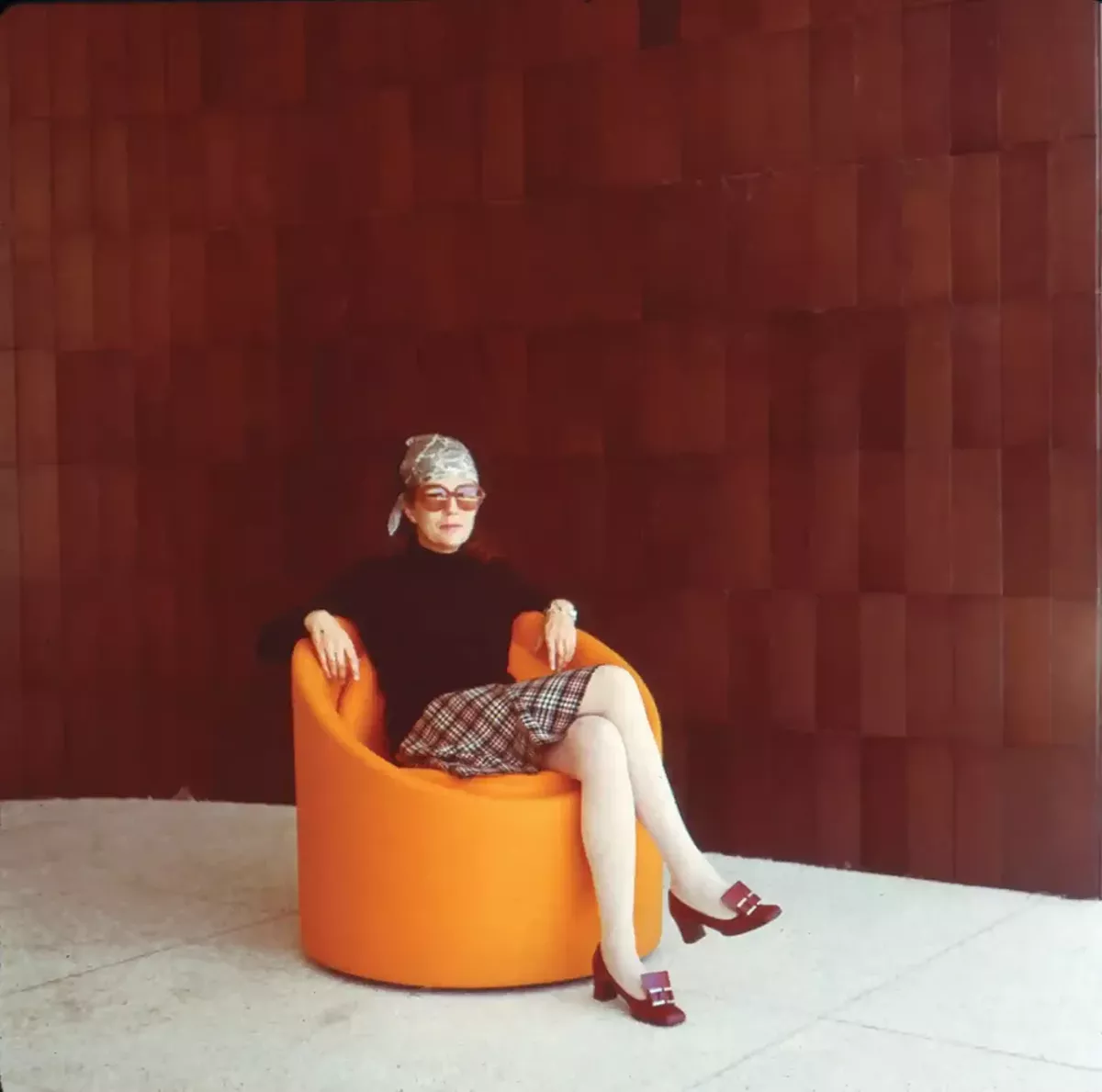 Kavanaugh in the mid-70s in her repurposed Sonotube chair upholstered in orange. Floyd's reissue of the chair will be featured in A Decade of Modularity.