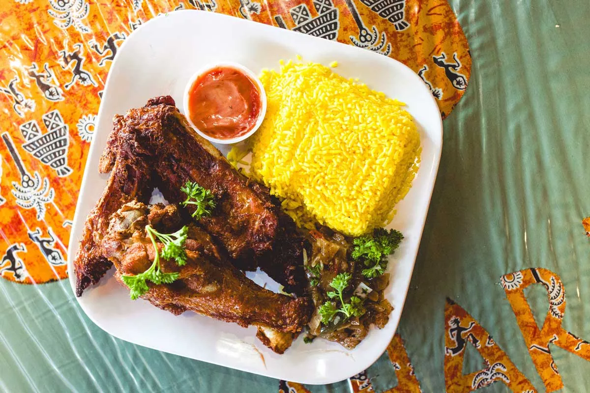 Image: Chicken drumsticks from Kalahari African Cuisine, warmly spiced and grilled a dark red brown.