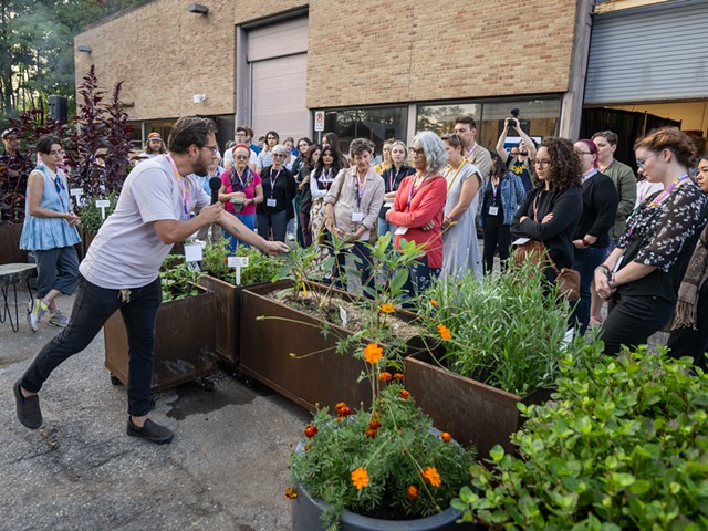 Stamps 2D media studio coordinator Nicholas Dowgwillo shows the new Sustainable Materials & Color Garden to students and faculty.