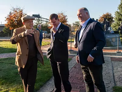 Flint Mayor Sheldon Neeley, left, speaks with U.S. Secretary of Labor Marty J. Walsh and Congressman Dan Kildee.