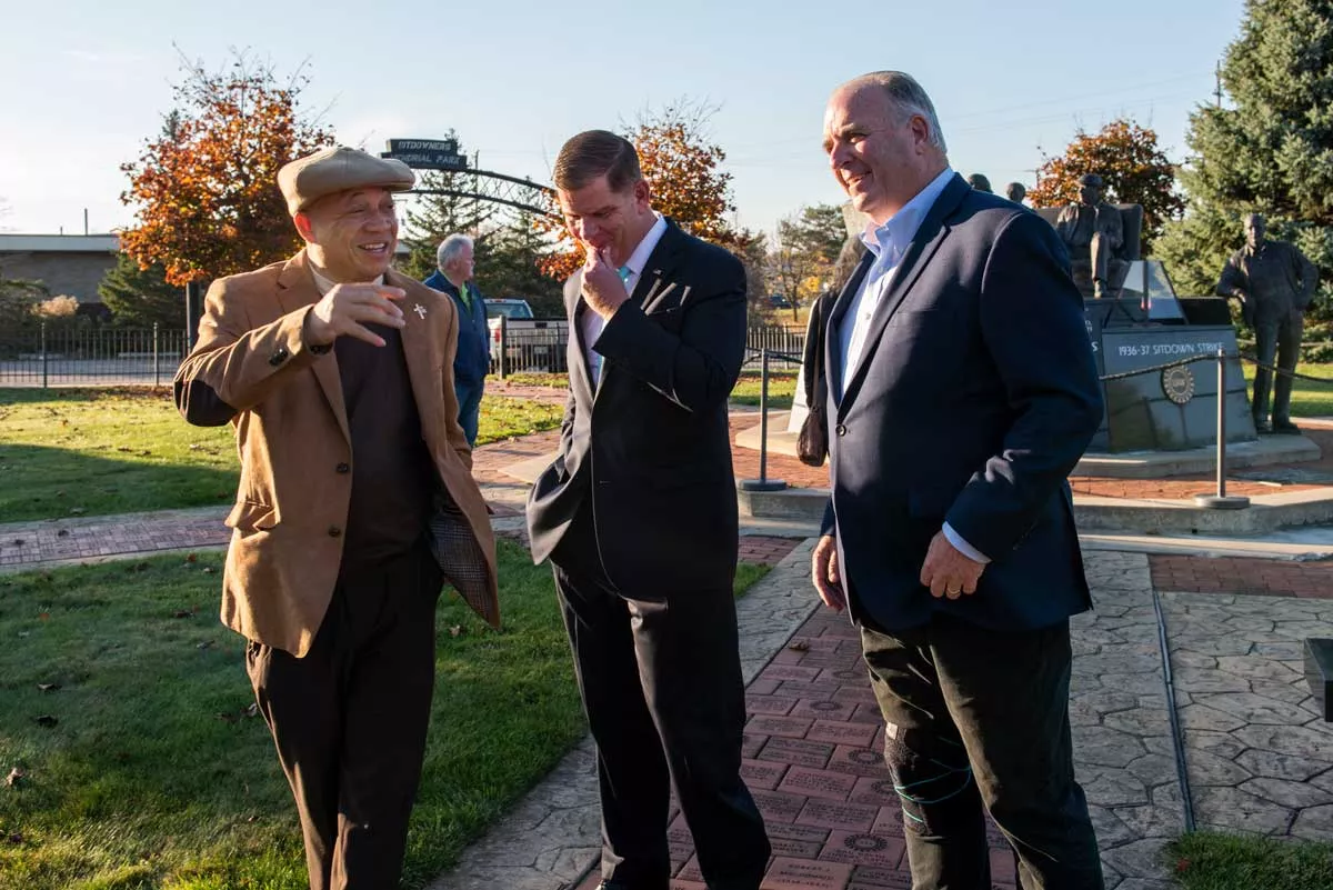 Image: Flint Mayor Sheldon Neeley, left, speaks with U.S. Secretary of Labor Marty J. Walsh and Congressman Dan Kildee.