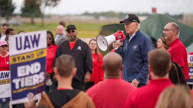 President Joe Biden, alongside UAW President Shawn Fain, speaks on the UAW picket line at Willow Run Redistribution Center in Belleville, Mich., Sept. 26, 2023.