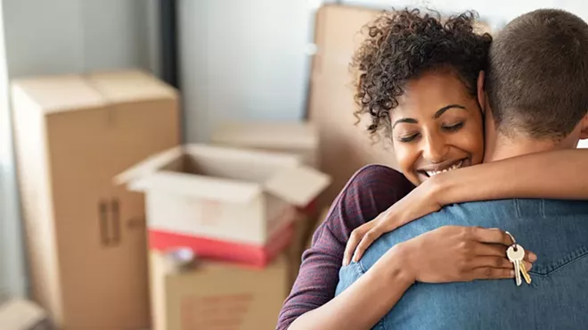 A photo showing a young couple moving in together.