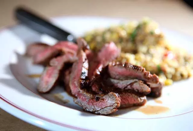 Chile-rubbed flank steak with grilled corn and quinoa salad from Vinsetta Garage in Royal Oak.