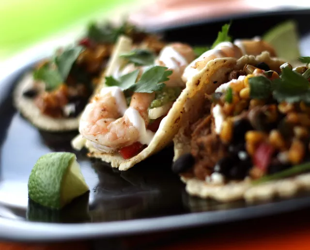 Chili lime shrimp taco, center, with a pair of braised pork tacos, from Burrito Mundo in Grosse Pointe Woods.