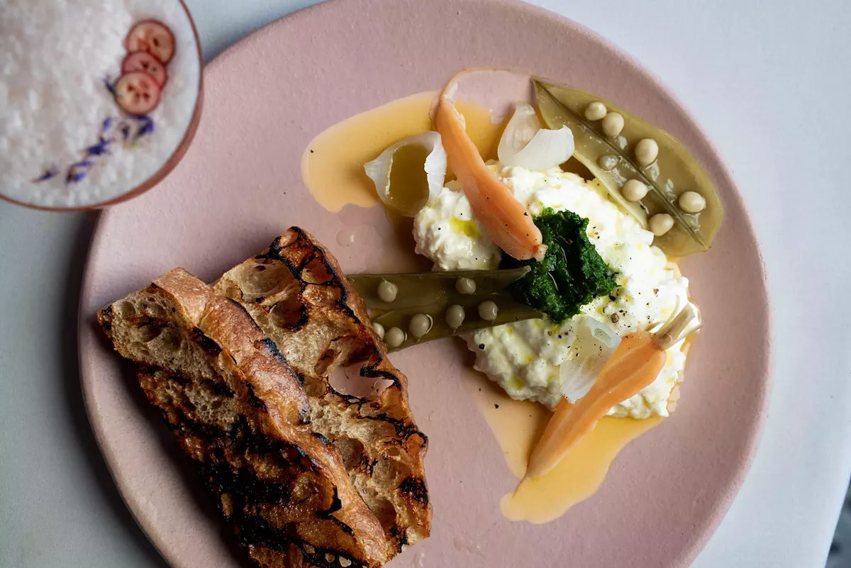 Stracciatella cheese served with pickled vegetables and grilled bread at Tiliani.