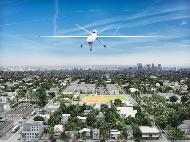 Surveillance UAV drone flying over a residential neighborhood.