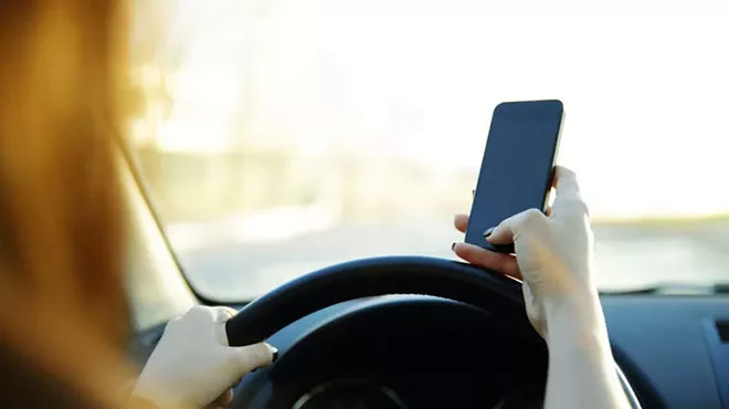 It’s against the law to use a cellphone with your hands while driving in Michigan.