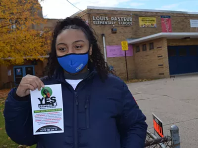 A voter urges a yes vote on the reparations ballot proposal, Nov. 2, 2021.