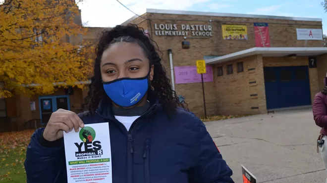 A voter urges a yes vote on the reparations ballot proposal, Nov. 2, 2021.