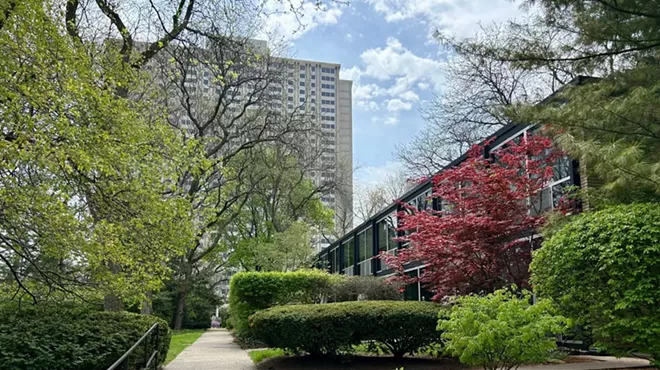 Residents of the 1300 Lafayette high-rise (background) want to use steam heat that would impact the Historic Lafayette Park townhouses (right).