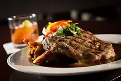 Dry Aged Michigan Rib Chop with duck fat frites, marrow butter and red wine jus, along with a Delta 88 cocktail (Bulleit rye whiskey, Cocchi Americano, Yellow Chartreuse, and lemon zest), from Local 212 in Royal Oak.